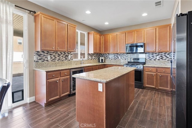 13695 Mesa Linda Ave, Victorville, CA 92392 - kitchen featuring appliances with stainless steel finishes, wine cooler, wood tiled floors, backsplash, and recessed lighting