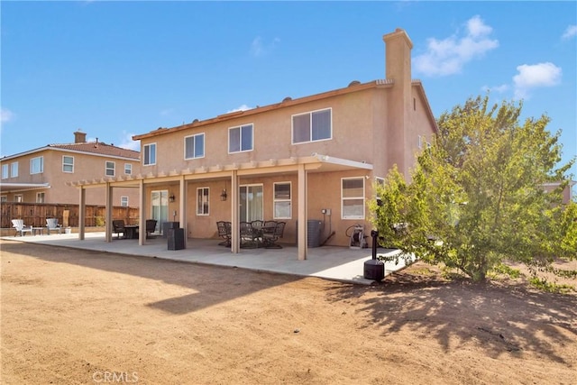 13695 Mesa Linda Ave, Victorville, CA 92392 - back of property featuring a patio area, stucco siding, a pergola, and a chimney