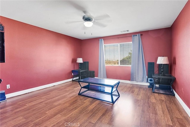 13695 Mesa Linda Ave, Victorville, CA 92392 - living area with wood finished floors, a ceiling fan, and a wood stove