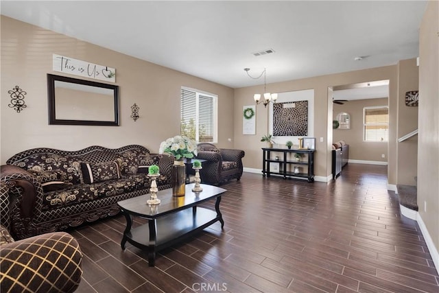 13695 Mesa Linda Ave, Victorville, CA 92392 - living room featuring plenty of natural light, a chandelier, and dark wood-type flooring