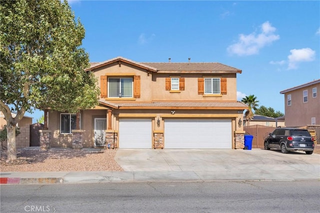 13695 Mesa Linda Ave, Victorville, CA 92392 - view of front of house featuring concrete driveway, stucco siding, a garage, and stone siding