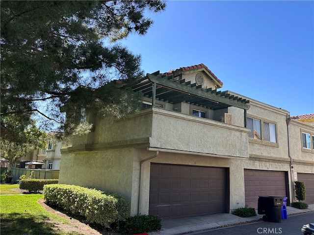 8426 Western Trail Pl Unit E, Rancho Cucamonga, CA 91730 - view of front of house featuring a garage, stucco siding, and a tile roof
