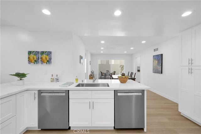 5042 Olympic Dr, Los Alamitos, CA 90720 - kitchen featuring stainless steel dishwasher, a peninsula, white cabinetry, recessed lighting, and light wood-style flooring