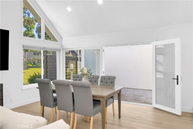 5042 Olympic Dr, Los Alamitos, CA 90720 - dining space with plenty of natural light, light wood finished floors, vaulted ceiling, and recessed lighting