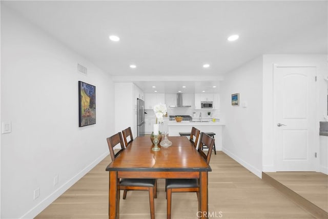 5042 Olympic Dr, Los Alamitos, CA 90720 - dining space with recessed lighting and light wood-style flooring
