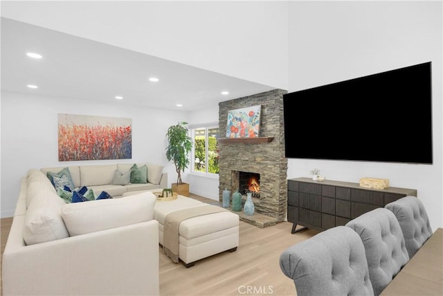 5042 Olympic Dr, Los Alamitos, CA 90720 - living room featuring wood finished floors, a fireplace, and recessed lighting
