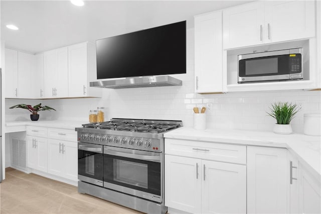 5042 Olympic Dr, Los Alamitos, CA 90720 - kitchen with stainless steel appliances, white cabinets, decorative backsplash, light stone counters, and recessed lighting