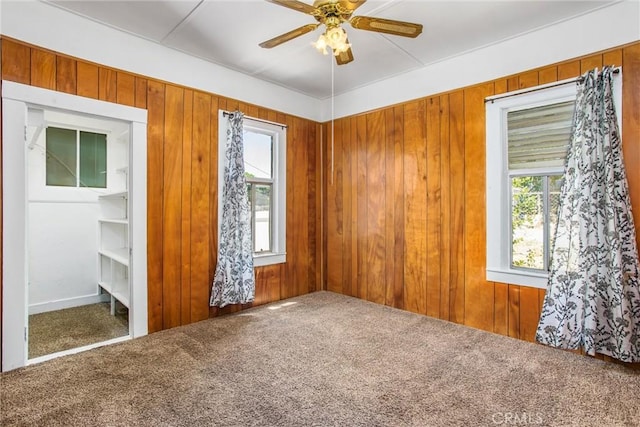 559 Edgar Ave Unit A2-282, Beaumont, CA 92223 - empty room with carpet, healthy amount of natural light, ceiling fan, and wooden walls