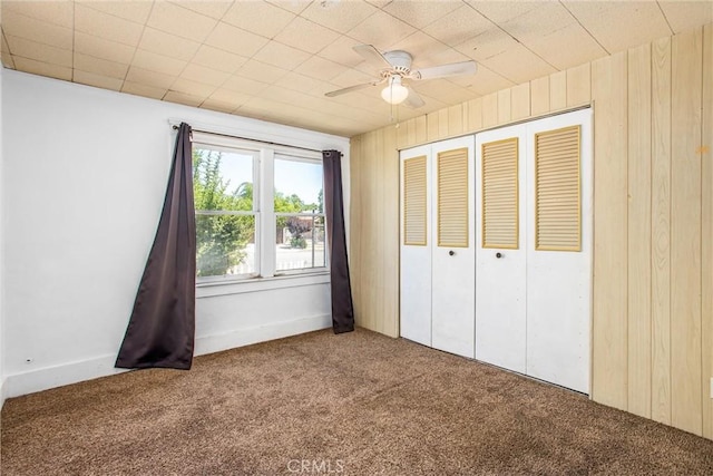 559 Edgar Ave Unit A2-282, Beaumont, CA 92223 - unfurnished bedroom featuring carpet flooring, wooden walls, a closet, and ceiling fan
