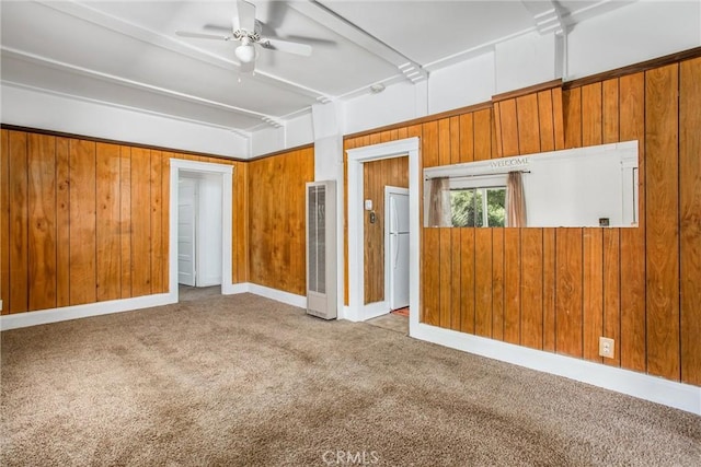 559 Edgar Ave Unit A2-282, Beaumont, CA 92223 - unfurnished room featuring a heating unit, carpet, a ceiling fan, and wood walls