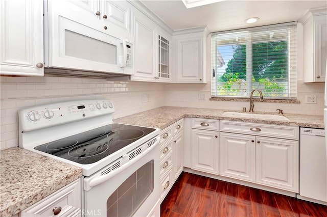 741 Avenida Majorca Unit B, Laguna Woods, CA 92637 - kitchen with white appliances, white cabinetry, dark wood-style floors, and tasteful backsplash