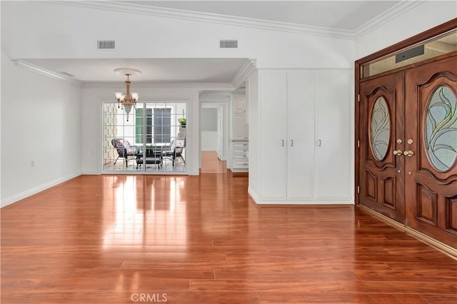 741 Avenida Majorca Unit B, Laguna Woods, CA 92637 - foyer featuring a chandelier, wood finished floors, and ornamental molding
