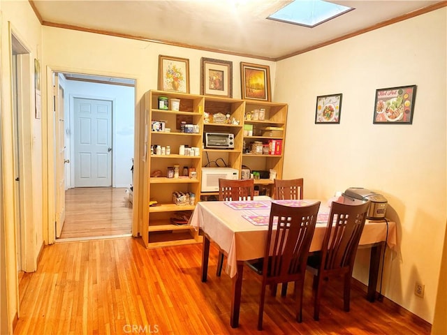 917 N Olive Ave, Alhambra, CA 91801 - dining room featuring a skylight, ornamental molding, and light wood-type flooring