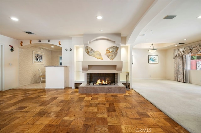 18409 Los Alimos St, Porter Ranch, CA 91326 - unfurnished living room featuring a lit fireplace, recessed lighting, and arched walkways