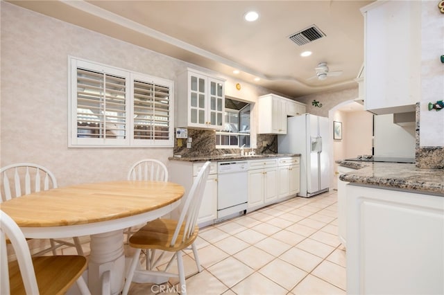18409 Los Alimos St, Porter Ranch, CA 91326 - kitchen with white appliances, white cabinetry, light tile patterned floors, backsplash, and glass insert cabinets