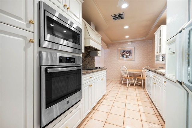 18409 Los Alimos St, Porter Ranch, CA 91326 - kitchen with appliances with stainless steel finishes, custom range hood, white cabinets, and recessed lighting