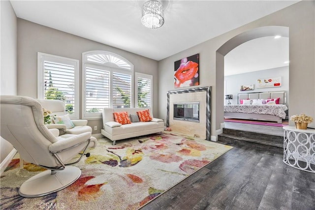 7020 Julie Ln, San Gabriel, CA 91775 - living room with wood finished floors, arched walkways, and a glass covered fireplace