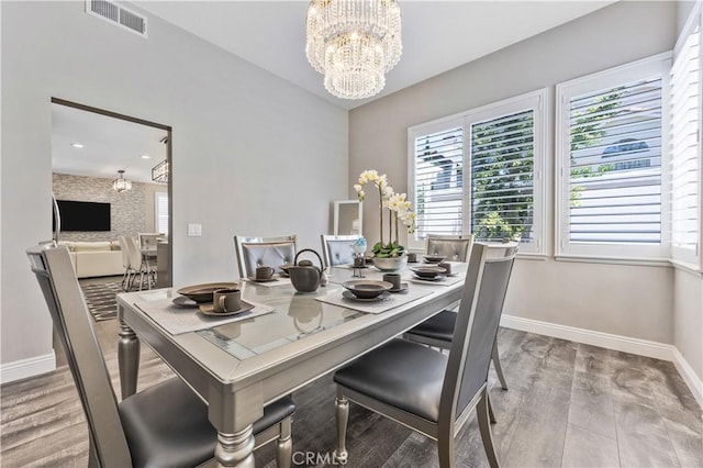 7020 Julie Ln, San Gabriel, CA 91775 - dining room featuring a chandelier, healthy amount of natural light, and wood finished floors