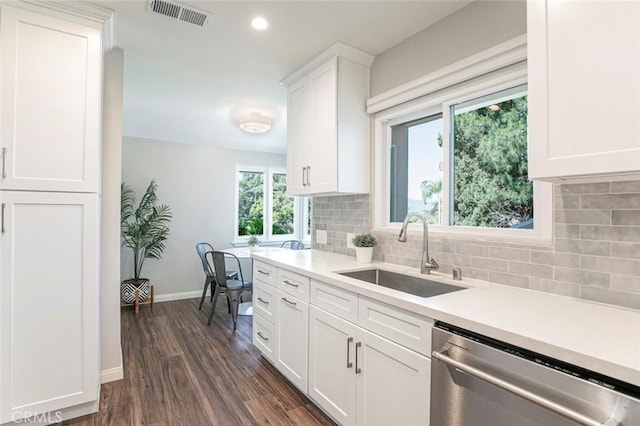 341 Cumberland Rd, Glendale, CA 91202 - kitchen with stainless steel dishwasher, dark wood-style floors, light countertops, tasteful backsplash, and white cabinets
