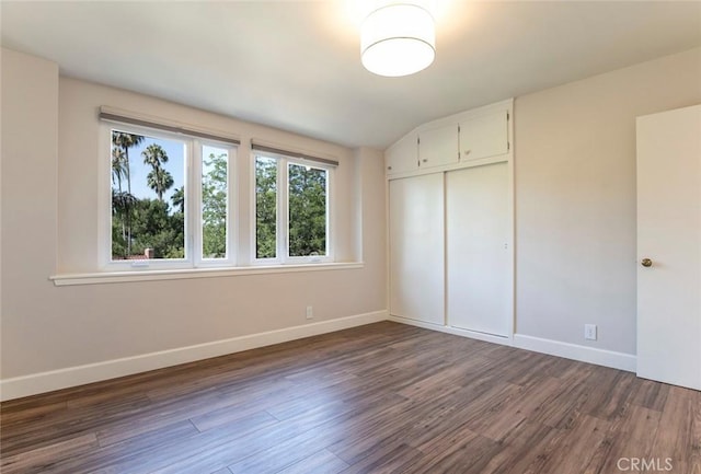 341 Cumberland Rd, Glendale, CA 91202 - unfurnished bedroom with dark wood-type flooring, a closet, and vaulted ceiling