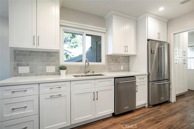 341 Cumberland Rd, Glendale, CA 91202 - kitchen featuring stainless steel appliances, white cabinetry, dark wood-style floors, light countertops, and tasteful backsplash