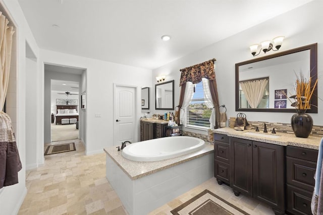3024 Natureview Ct, Chula Vista, CA 91914 - bathroom with a bath, two vanities, connected bathroom, a ceiling fan, and recessed lighting