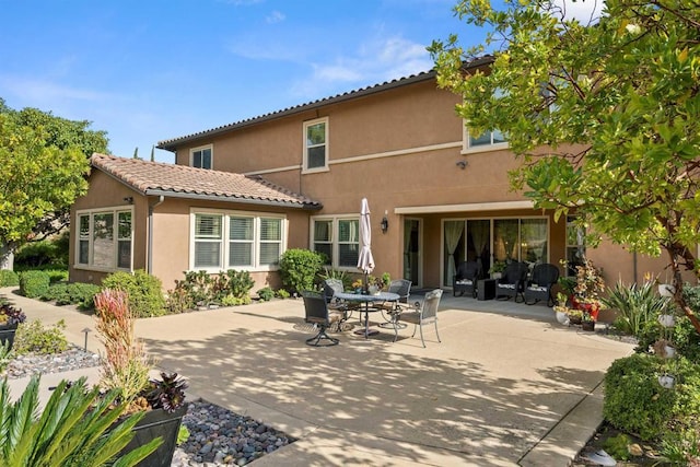 3024 Natureview Ct, Chula Vista, CA 91914 - back of property featuring a patio, stucco siding, a tile roof, and outdoor dining space