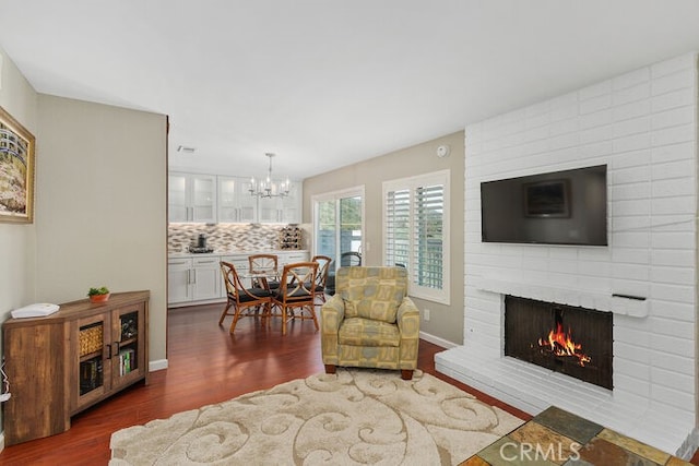 32332 Calle Linda, Dana Point, CA 92629 - living area with a brick fireplace, wood finished floors, and a chandelier