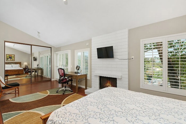 32332 Calle Linda, Dana Point, CA 92629 - bedroom featuring lofted ceiling, a fireplace, and wood finished floors