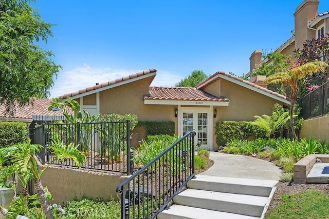 32332 Calle Linda, Dana Point, CA 92629 - mediterranean / spanish-style home featuring a tile roof, stucco siding, and french doors