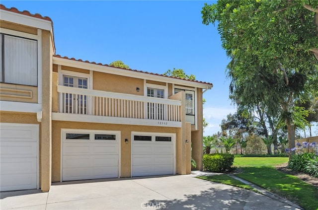 32332 Calle Linda, Dana Point, CA 92629 - view of front of house featuring a tile roof, stucco siding, driveway, an attached garage, and a balcony