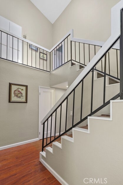 32332 Calle Linda, Dana Point, CA 92629 - staircase featuring wood finished floors and a high ceiling