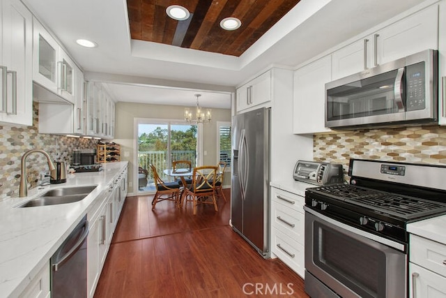 32332 Calle Linda, Dana Point, CA 92629 - kitchen with stainless steel appliances, a raised ceiling, a chandelier, glass insert cabinets, and wood ceiling