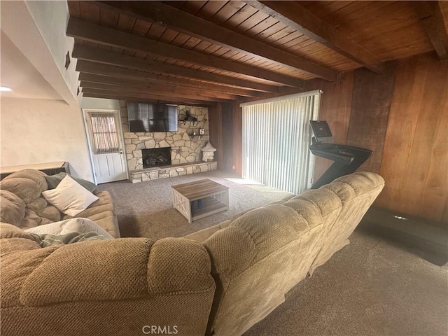 1024 W Pine St, West Covina, CA 91790 - carpeted living room with a wood ceiling with exposed beams, wooden walls, and a stone fireplace