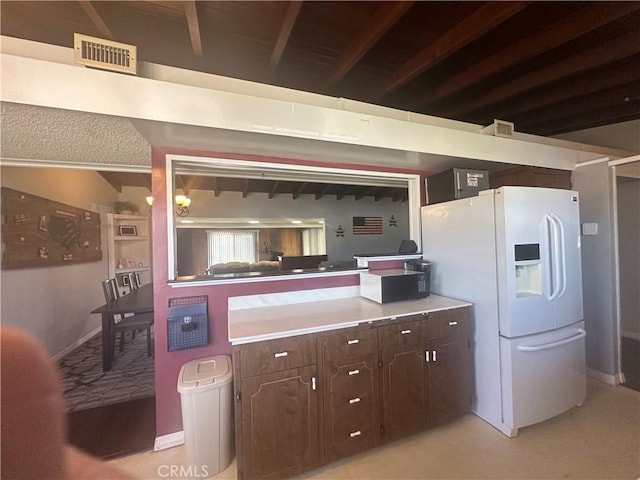 1024 W Pine St, West Covina, CA 91790 - kitchen featuring white fridge with ice dispenser, dark brown cabinetry, beamed ceiling, light countertops, and a peninsula