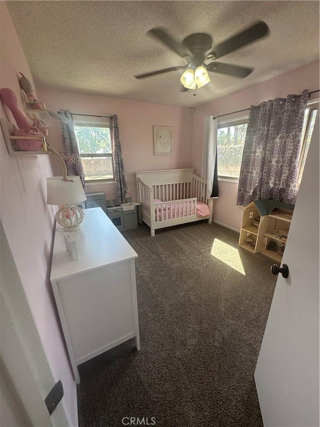 1024 W Pine St, West Covina, CA 91790 - bedroom featuring a textured ceiling, multiple windows, dark colored carpet, and ceiling fan