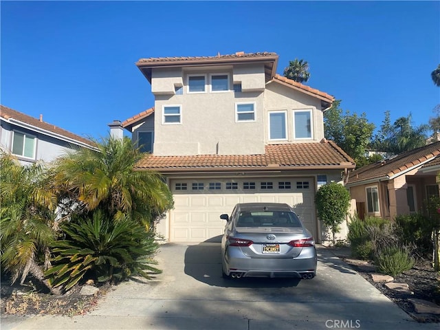 1853 Corte Pulsera, Oceanside, CA 92056 - mediterranean / spanish-style house featuring a tile roof, concrete driveway, an attached garage, and stucco siding