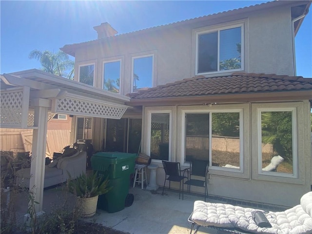 1853 Corte Pulsera, Oceanside, CA 92056 - back of property featuring a patio, a tiled roof, a chimney, and stucco siding
