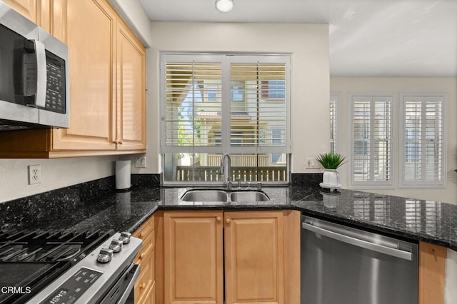 489 W Summerfield Cir, Anaheim, CA 92802 - kitchen with stainless steel appliances, plenty of natural light, light brown cabinetry, and dark stone counters