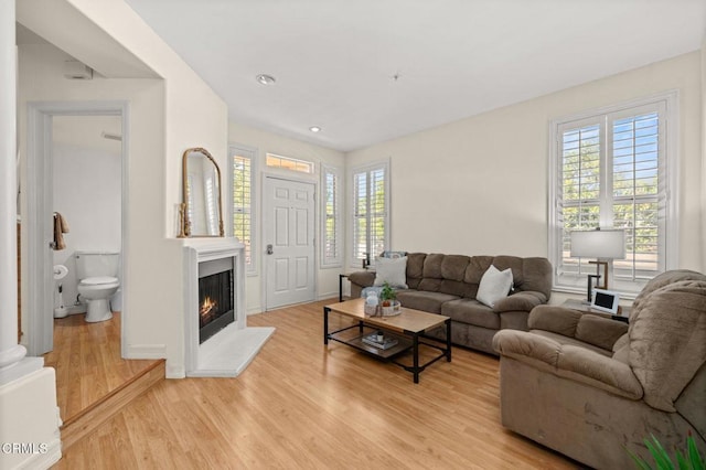 489 W Summerfield Cir, Anaheim, CA 92802 - living area with light wood finished floors and a warm lit fireplace