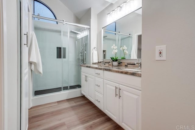 11033 Scripps Ranch Blvd, San Diego, CA 92131 - bathroom with double vanity, a stall shower, and wood finished floors