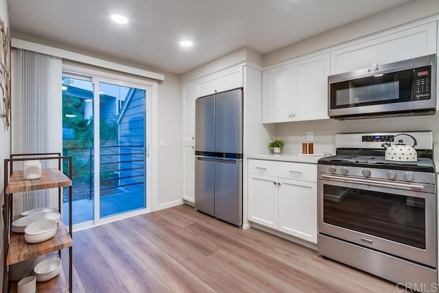 11033 Scripps Ranch Blvd, San Diego, CA 92131 - kitchen featuring appliances with stainless steel finishes, light wood-style flooring, white cabinets, light countertops, and recessed lighting