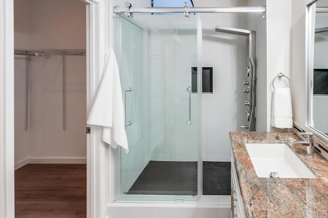 11033 Scripps Ranch Blvd, San Diego, CA 92131 - bathroom with a shower stall, vanity, a walk in closet, and wood finished floors