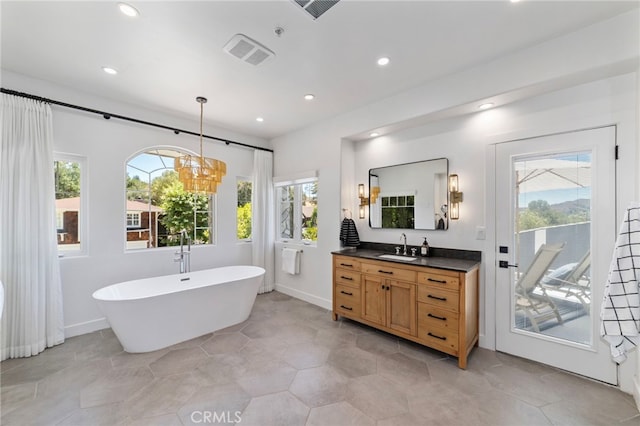 31675 Via Pato, Coto De Caza, CA 92679 - bathroom with vanity, healthy amount of natural light, a freestanding tub, a chandelier, and recessed lighting