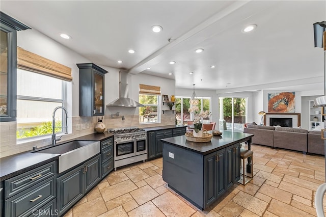 31675 Via Pato, Coto De Caza, CA 92679 - kitchen featuring wall chimney exhaust hood, double oven range, dark countertops, stone tile flooring, and recessed lighting