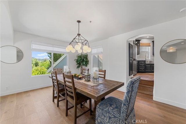 31675 Via Pato, Coto De Caza, CA 92679 - dining room featuring light wood-style floors, arched walkways, and a chandelier