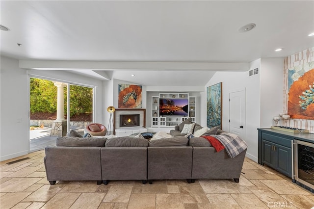 31675 Via Pato, Coto De Caza, CA 92679 - living room featuring beverage cooler, stone tile floors, recessed lighting, a warm lit fireplace, and a dry bar