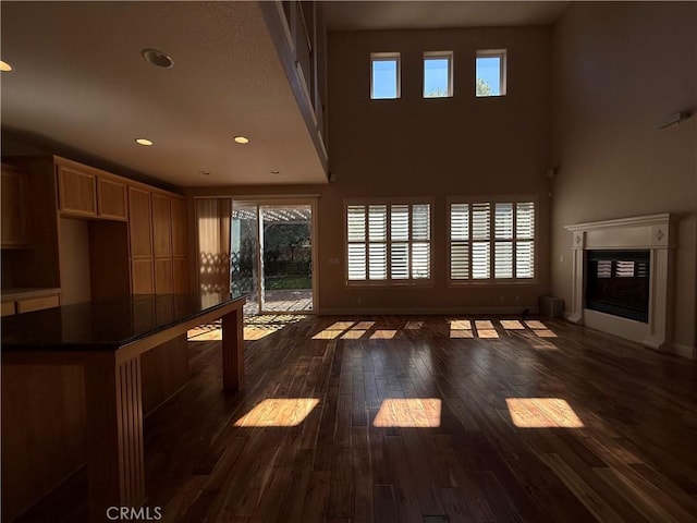 4125 Sattui Ct, Merced, CA 95348 - unfurnished living room with dark wood finished floors, a glass covered fireplace, and recessed lighting