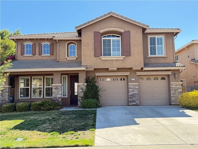 4125 Sattui Ct, Merced, CA 95348 - view of front of property featuring a tiled roof, an attached garage, driveway, and stucco siding