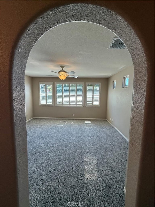 4125 Sattui Ct, Merced, CA 95348 - empty room with a ceiling fan, arched walkways, and healthy amount of natural light